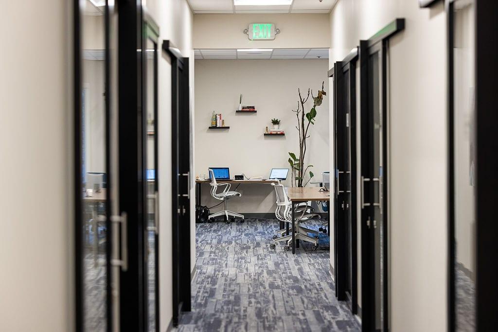 Corridor of glass-door private offices at Granite City Workspaces, Folsom CA