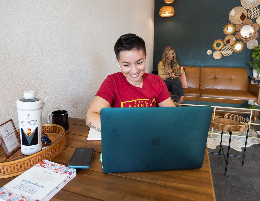 Woman smiling at laptop in the Granite City Workspaces lounge