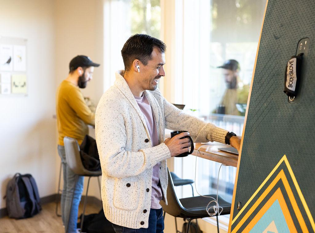 Man with coffee at standing desk at Granite City Workspaces