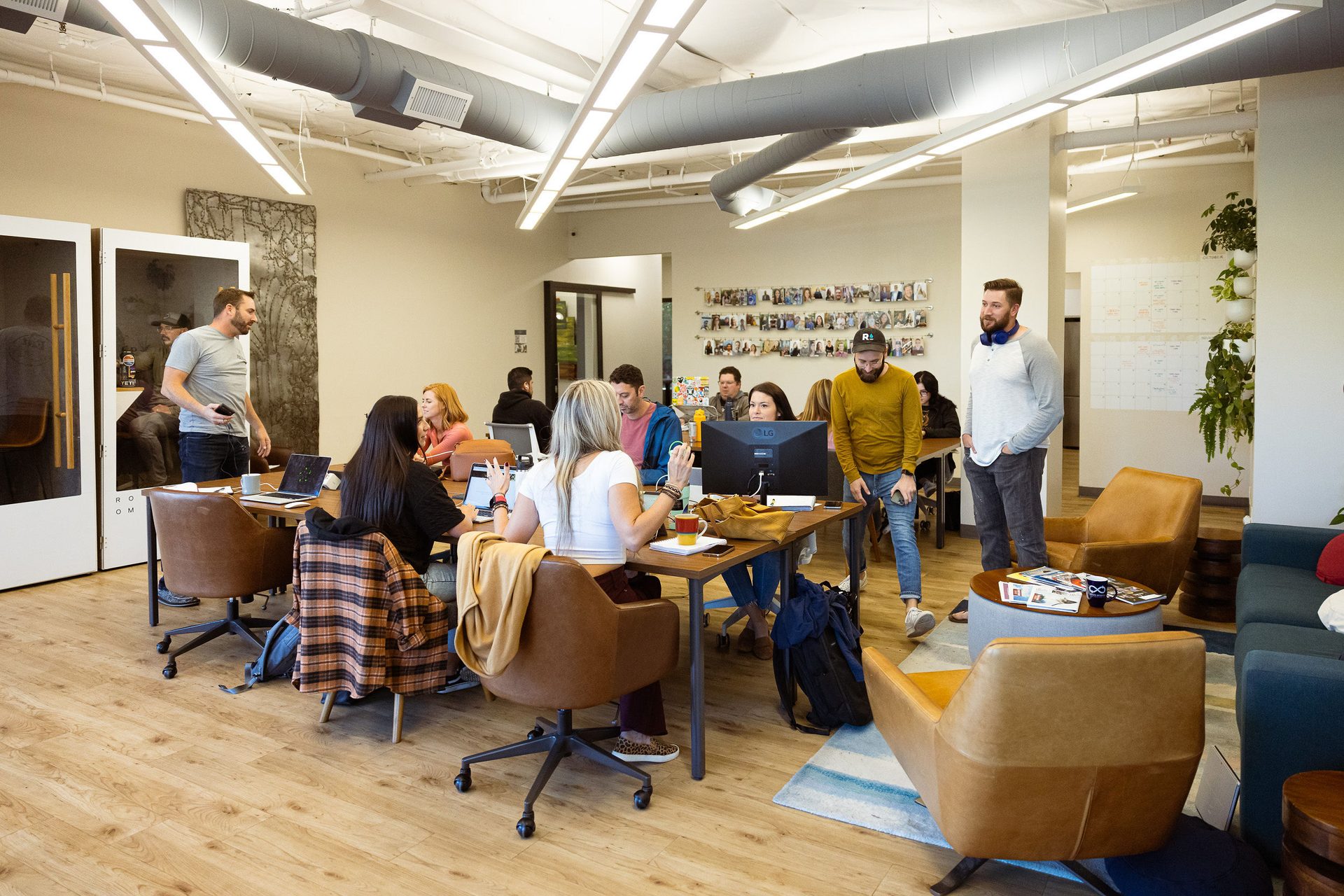 Members working together at shared tables on the open coworking floor at Granite City Workspaces in Folsom