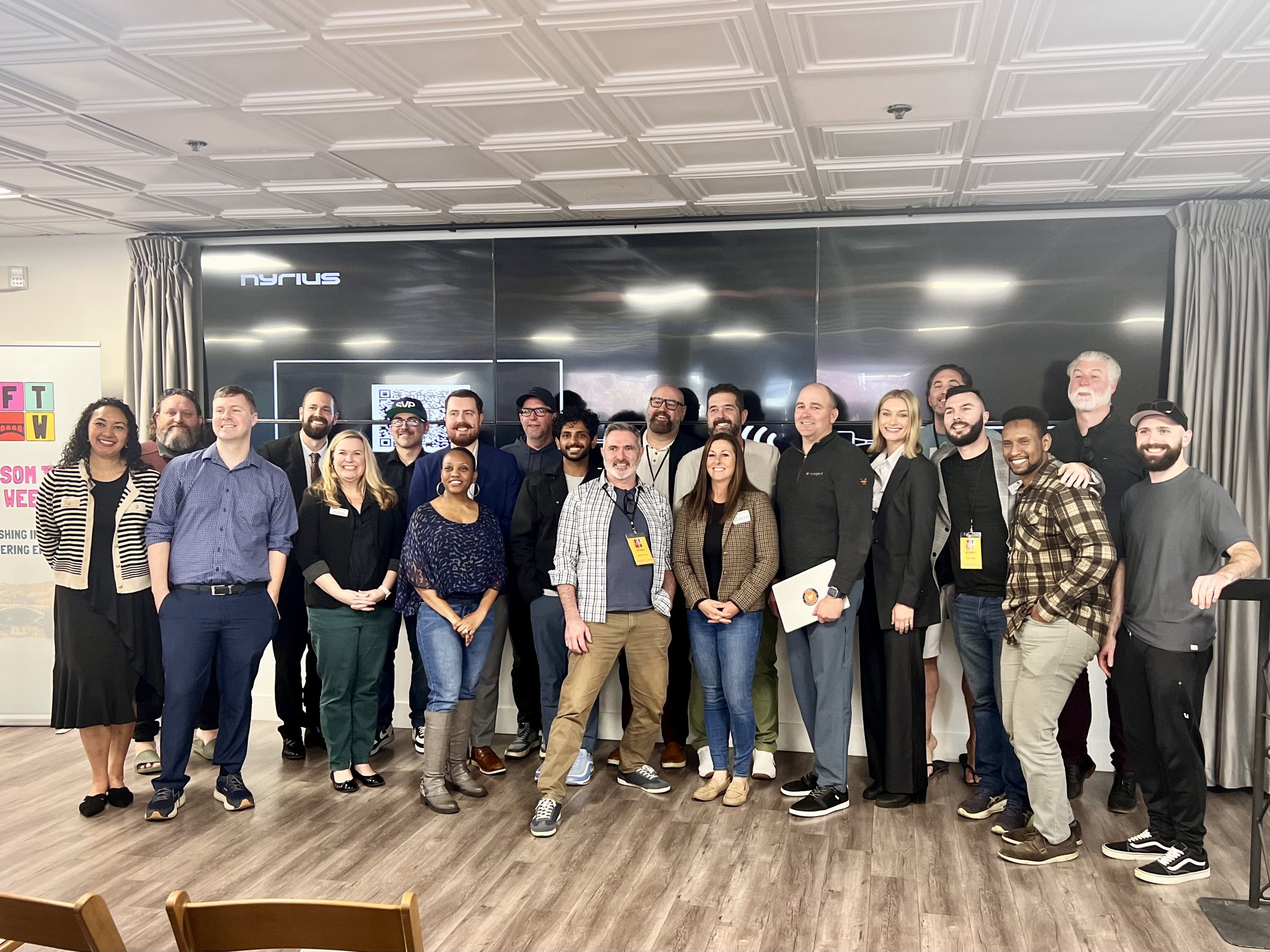 A large group posed together in the Commons at Granite City Workspaces in Folsom during a hackathon