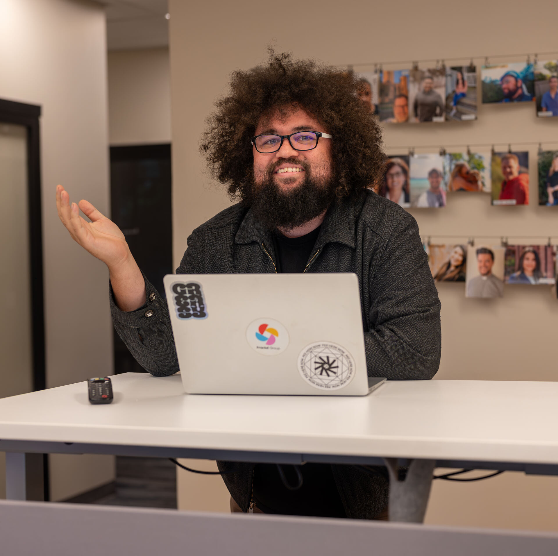 Granite City member smiling while working at a standing desk with a laptop