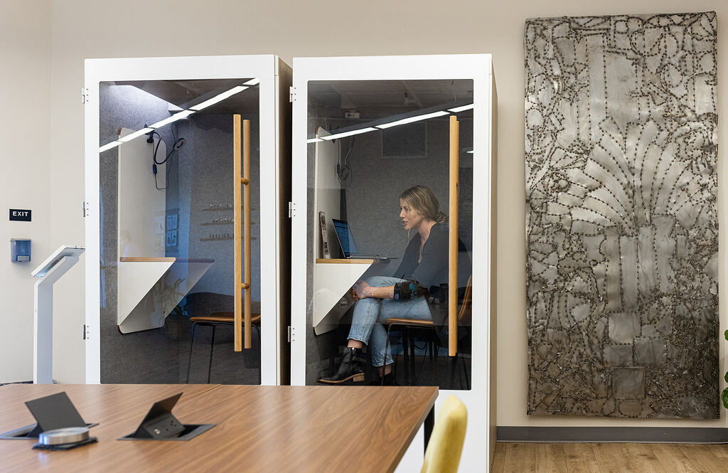 Two soundproof phone booths in use for private calls at Granite City Workspaces